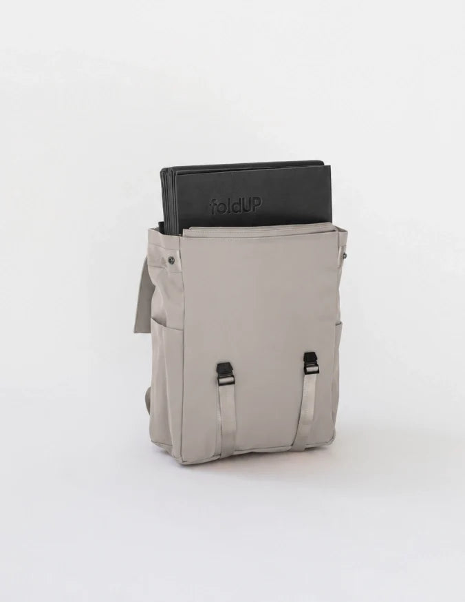Folded black foldUP Movement Mat inside an open Light Grey Everyday Bag.