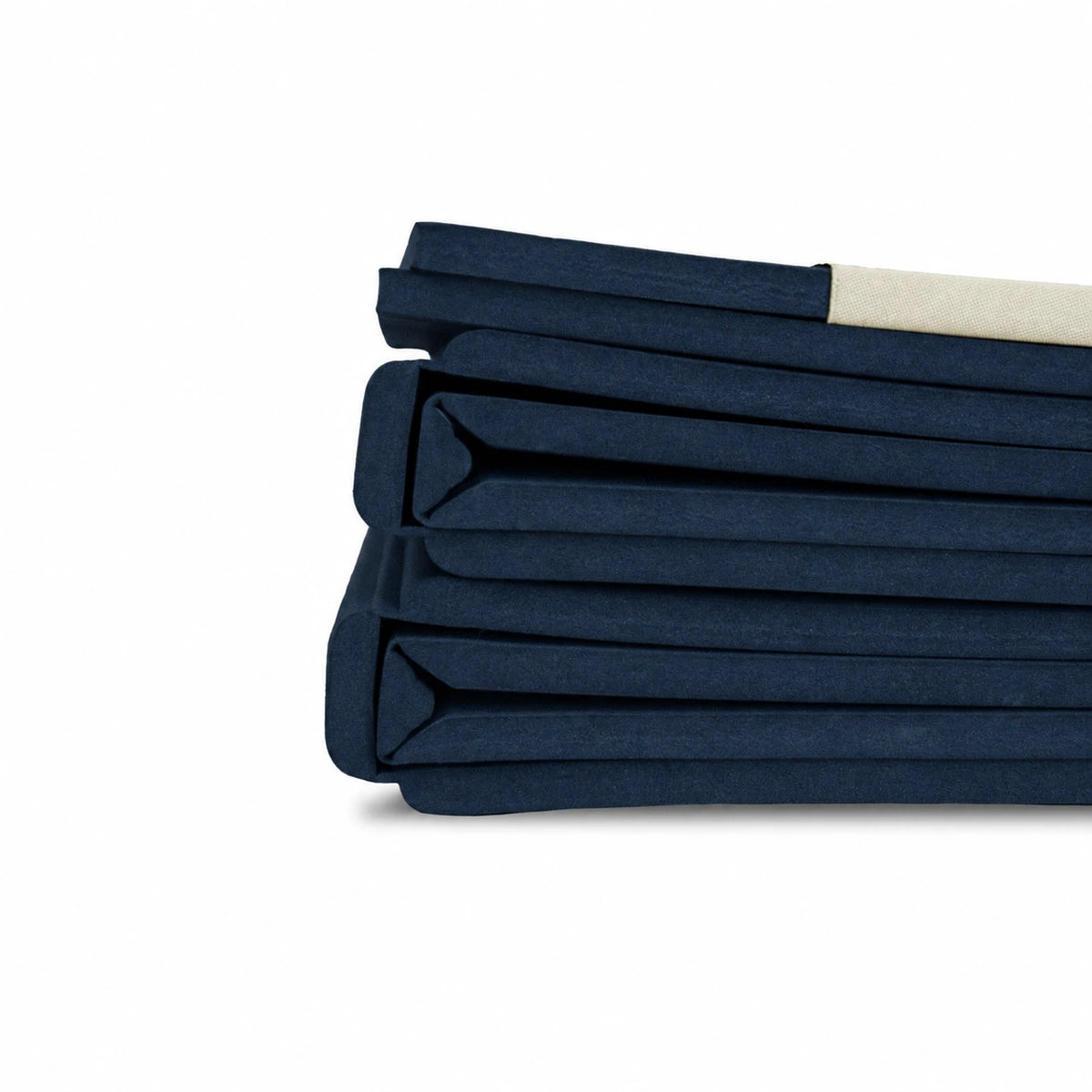 Side view of a navy Movement Mat folded into a compact stack, showing its layered edges.